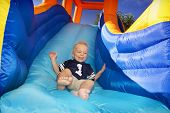 picture of laughter  - Boy sliding down an inflatable Side - JPG 