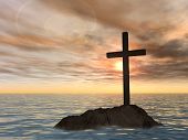 stock photo of religion  - Concept or conceptual dark christian cross standing on a rock in the sea or ocean over a beautiful sky at sunset as a metaphor for faith - JPG 