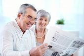 pic of newspaper  - Portrait of mature couple reading newspaper together - JPG 