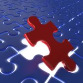 stock photo of puzzle  - fitting the last piece of a puzzle as concept for achievment or success - JPG 