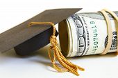 foto of finance  - a graduation cap and cash roll closeup - JPG 