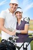 stock photo of golf  - cheerful couple on golf course - JPG 