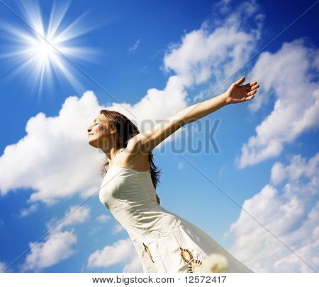 Picture or Photo of Beautiful Young Woman over blue Sky