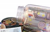 foto of money  - A Money jar full of Euro bank notes and coins against white background - JPG 