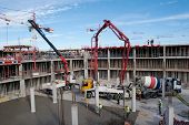 pic of construction  - Construction site with cement mixer and blue sky - JPG 