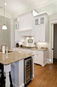 image of opulence  - opulent white kitchen with granite countertops and wine fridge - JPG 