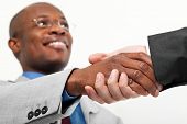 stock photo of meeting  - African businessman shaking hands with a caucasian one - JPG 