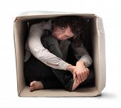 pic of pressure  - Man crouched in a box - JPG 