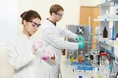 stock photo of science  - Two female and male researchers carrying out scientific research chemistry laboratory - JPG 