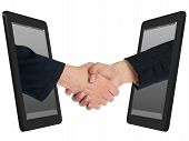 foto of handshake  - Two Computer Device and Hands in handshaking Internet Working Concept Wireless Communication Online Business - JPG 