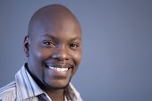 stock photo of africanamerican  - african american looking into camera and smiling - JPG 