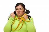 picture of woman  - Attractive Frustrated Hispanic Woman Tied Up With Tape Measure Against a White Background - JPG 