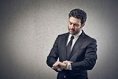 pic of watch  - young businessman looking his watch - JPG 