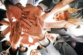 picture of teamwork  - business people teamwork in an office with hands together - JPG 