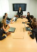 image of meeting  - businesspeople in a business meeting in an office smiling - JPG 