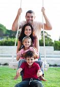 picture of family  - Family having fun on a swing - JPG 