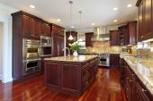 stock photo of interior  - Kitchen in luxury home with cherry wood cabinetry - JPG 