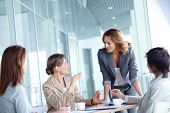 picture of meeting  - Image of four businesswomen interacting at meeting - JPG 