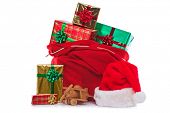 picture of wrapped  - Photo of a red Santa Claus hat and sack full of gift wrapped presents and toys - JPG 