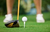 image of golf  - Golf ball and stick with golfer legs in background - JPG 