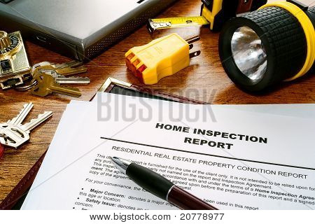 Picture or Photo of Real estate home inspection report of resale residential property condition with professional housing engineering inspector testing tools and house keys (fictitious but realistic document)