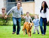 stock photo of family  - Happy family running at the backyard and having fun - JPG 