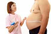 picture of medical doctors  - Woman doctor with a medical examination in obese patient - JPG 