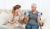 pic of home  - Lovely nurse helping her patient to do exercises at home - JPG 