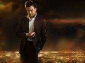 foto of man  - Elegant young handsome man over night city background - JPG 