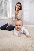 image of curiosity  - Mother with baby learning to crawl at home on carpet
 - JPG 