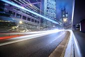 foto of bridge  - Fast moving cars lights blurred over modern city background - JPG 
