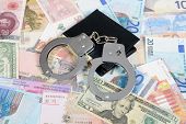 picture of currency  - Currency from world with handcuffs and wallet - JPG 