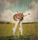 stock photo of surreal  - Fantasy artistic image that represent feet tiptoe and calves of a classic ballerina in a ballet slippers with a surreal mechanism of gears that supposed to move them in a surreal background - JPG 