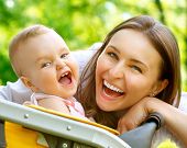 stock photo of future  - Laughing Mother And Baby outdoors - JPG 