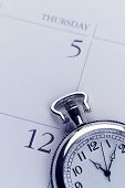 stock photo of watch  - Closeup of watch on calendar - JPG 