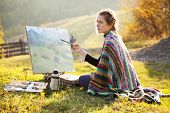 foto of hours  - Young artist painting an autumn landscape - JPG 