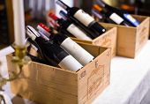 image of group  - Wine bottles in wooden boxes are on the table restaurant - JPG 