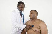 picture of pressure  - An African American doctor checking blood pressure of a patient in clinic - JPG 