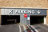stock photo of entrance  - Entrance to the parking lot in stone brickwork wall - JPG 