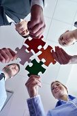 foto of puzzle  - Group of business people assembling jigsaw puzzle and represent team support and help concept - JPG 