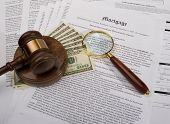 pic of fraud  - Mortgage documents with a gavel cash and magnifying glass - JPG 