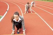 image of competition  - Businesswoman at athletic stadium and race track - JPG 