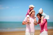 stock photo of family  - Young happy family with two kids on beach vacation - JPG 