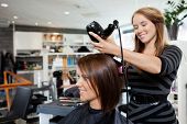 foto of woman  - Beautician blow drying woman - JPG 