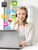 stock photo of helpline  - smiling female helpline operator with headphones and laptop - JPG 