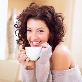 foto of home  - Young woman at home sipping tea from a cup - JPG 