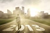 pic of future  - Businessman is walking on the road to embrace new year 2013 - JPG 