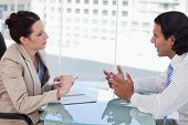stock photo of meeting  - Young business people negotiating in a meeting room - JPG 