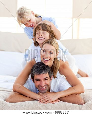 Picture or Photo of Happy family having fun in the bedroom