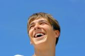 picture of blue sky  - cheerful teenager isolated on the blue sky - JPG 